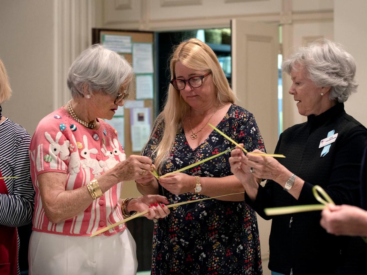 Sally Alice Smith, from left, teaches Marie Leidy and Lea Thompson how to make palm crosses Friday at Bethesda-by-the-Sea in preparation for Palm Sunday services.