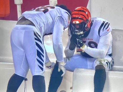 Cincinnati Bengal Devin Asiasi, left, comforts teammate Joseph Ossai at the end of the NFL’s American Conference championship game Jan. 29 after a mistake by Ossai was followed by Kansas City’s winning field goal.