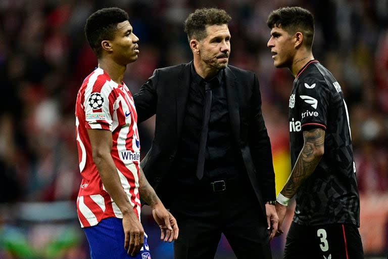 El entrenador argentino del Atlético de Madrid, Diego Simeone (C), reacciona con el defensor mozambiqueño del Atlético de Madrid, Reinildo Mandava (L), al final de la primera ronda de la Liga de Campeones de la UEFA, día 5, partido de fútbol del Grupo B entre el Club Atlético de Madrid y el Bayer Leverkusen en el estadio Wanda Metropolitano. en Madrid el 26 de octubre de 2022. (Foto de JAVIER SORIANO / AFP)