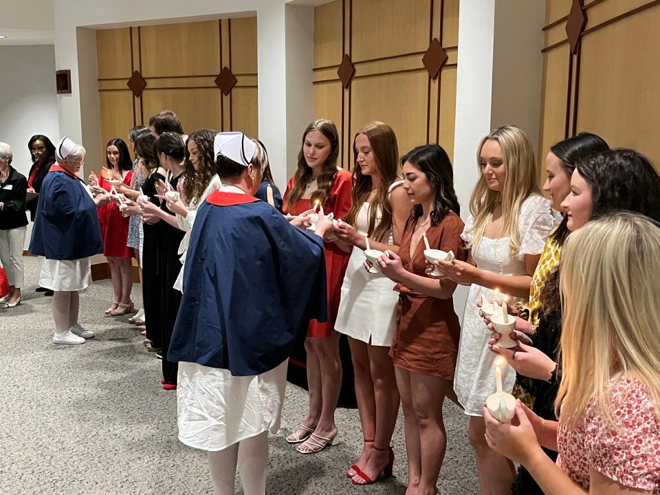 TTUHSC BSN graduates make the Florence Nightingale pledge with ceremonial lamp lighting as the first graduating class of the TTUHSC School of Nursing Thursday at the TTUHSC Jerry H. Hodge School of Pharmacy Harrington Auditorium.