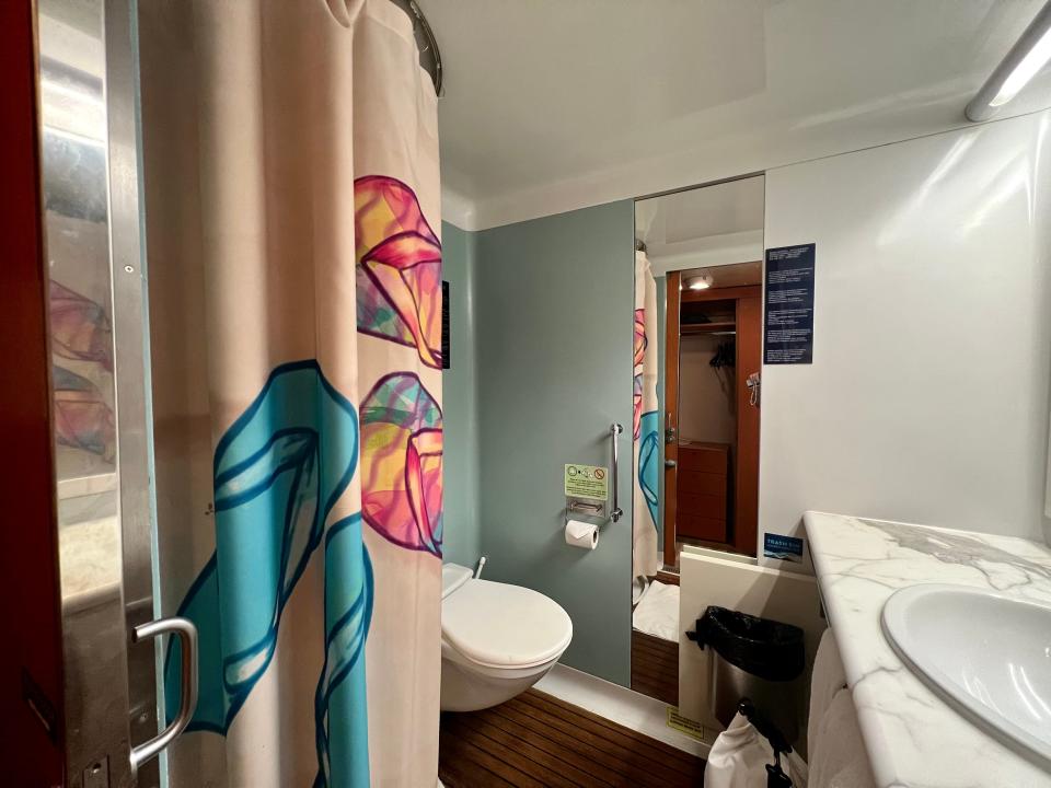 Margaritaville at Sea interior stateroom bathroom toilet, mirror in background, shower on lef