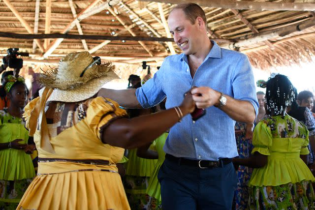 JOHAN ORDONEZ/AFP via Getty Prince William dances in Belize on March 20, 2022