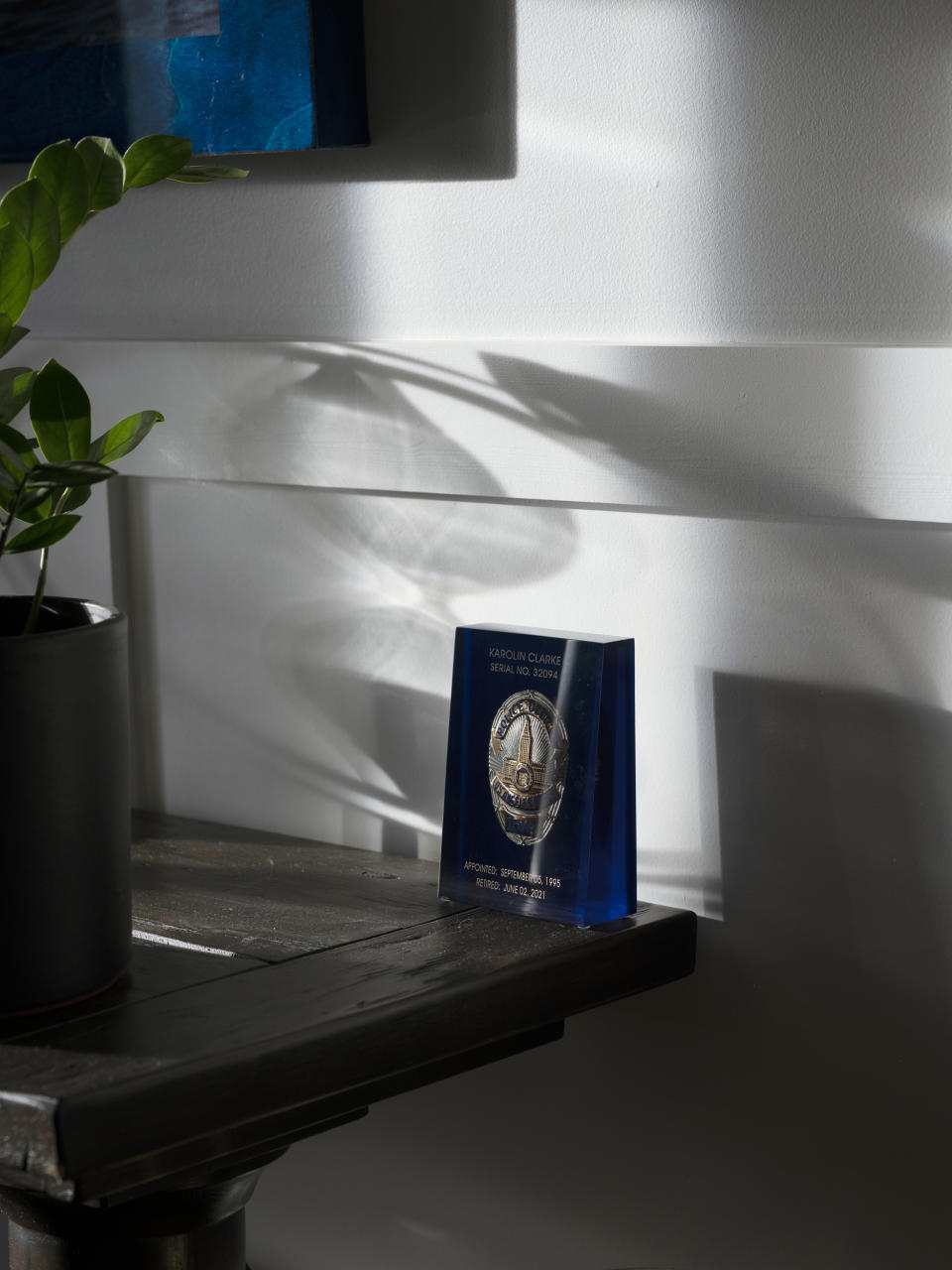 Karolin Clarke keeps her encased LAPD badge on a desk in her home. (Tamara Reynolds for NBC News)