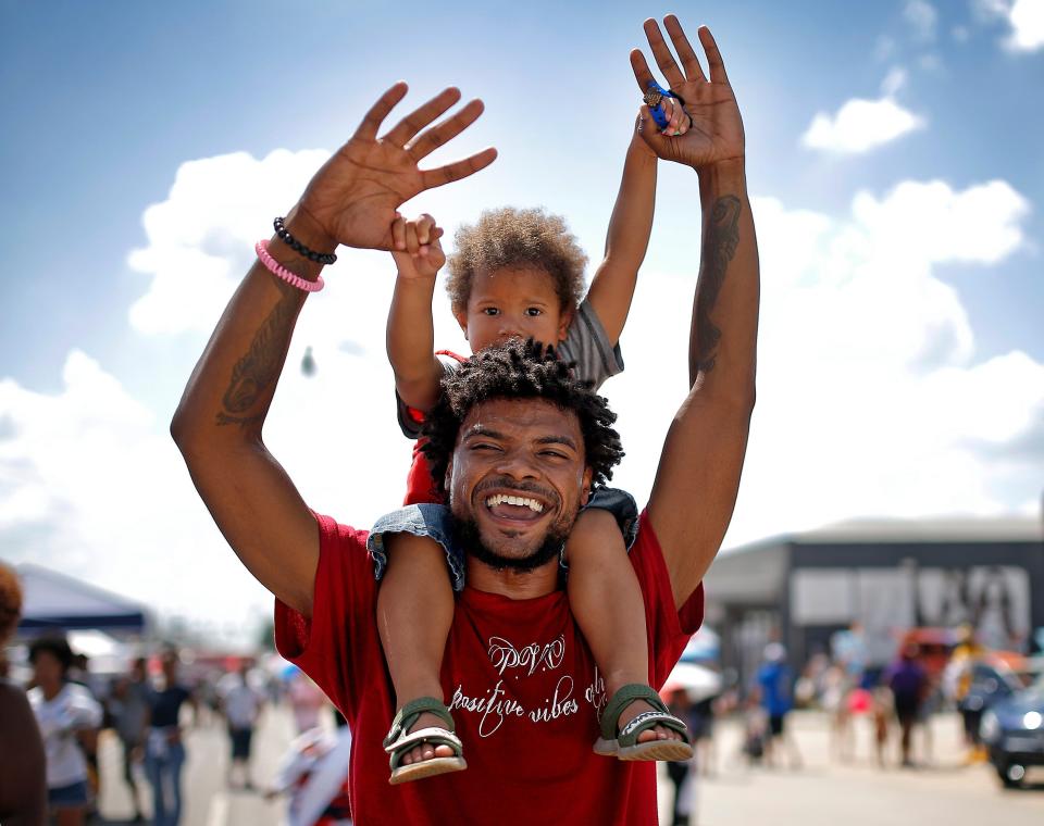 Tre Fairbanks dances with Zuri, 4, during Juneteenth on East in Oklahoma City, Oklahoma, on June, 18, 2022.