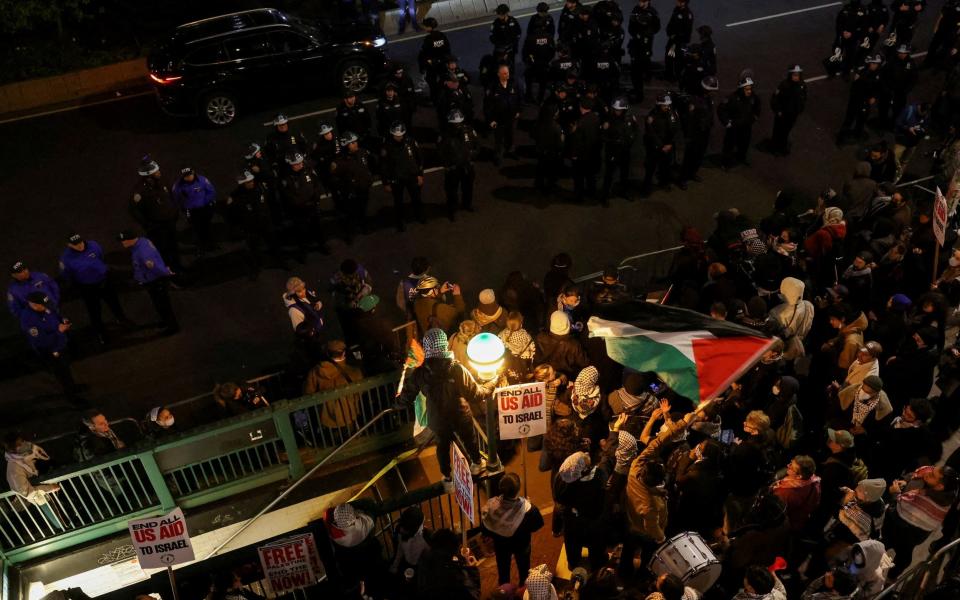 Demonstrators face off with police outside the university's main entrance