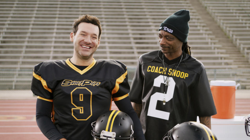 This photo provided by Skechers shows Tony Romo and Snoop Dogg from a scene from Skechers 2023 Super Bowl NFL football spot. ( Skechers via AP)