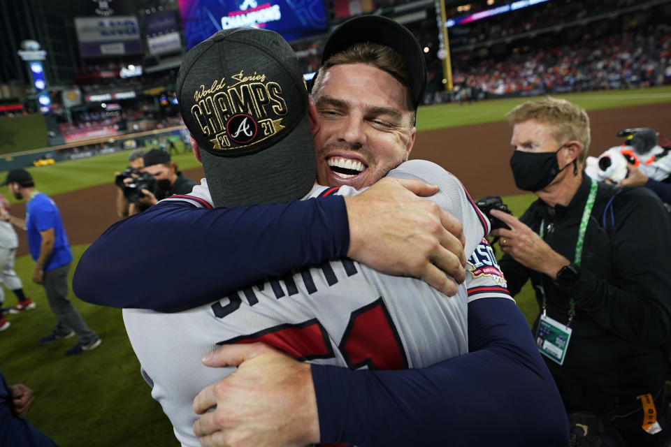 Atlanta Braves first baseman Freddie Freeman hugs relief pitcher Will Smith after winning baseball's World Series in Game 6 against the Houston Astros Tuesday, Nov. 2, 2021, in Houston. The Braves won 7-0. (AP Photo/David J. Phillip)