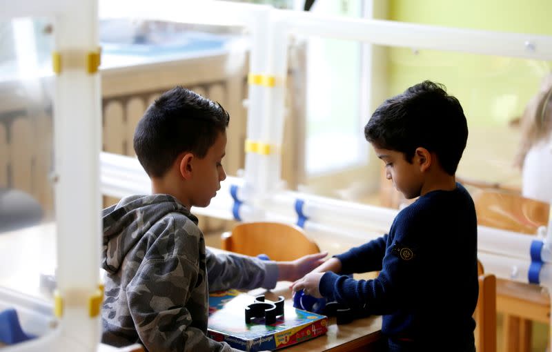 FILE PHOTO: Demonstration of the use of sneeze guards at a nursery school in Velbert