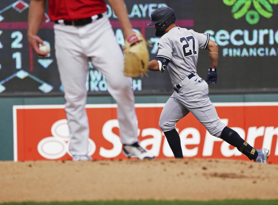 New York Yankees' Giancarlo Stanton (27) circles the bases on a solo home run off Minnesota Twins pitcher Cole Sands during the first inning of a baseball game Tuesday, June 7, 2022, in Minneapolis. (AP Photo/Jim Mone)