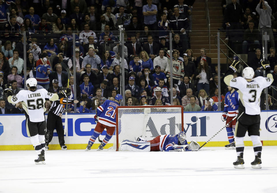 Pittsburgh Penguins' Olli Maatta (3) and Kris Letang (58) celebrate a goal by Brandon Sutter as New York Rangers goalie Henrik Lundqvist, center, of Sweden, reacts during the second period of a second-round NHL Stanley Cup hockey playoff series Wednesday, May 7, 2014, in New York. (AP Photo/Frank Franklin II)