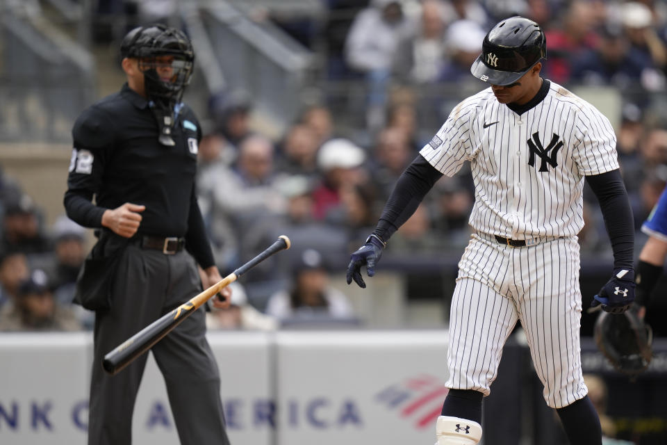 New York Yankees' Juan Soto throws his bat after striking out during the eighth inning of the baseball game against the Toronto Blue Jays at Yankee Stadium Friday, April 5, 2024, in New York. (AP Photo/Seth Wenig)