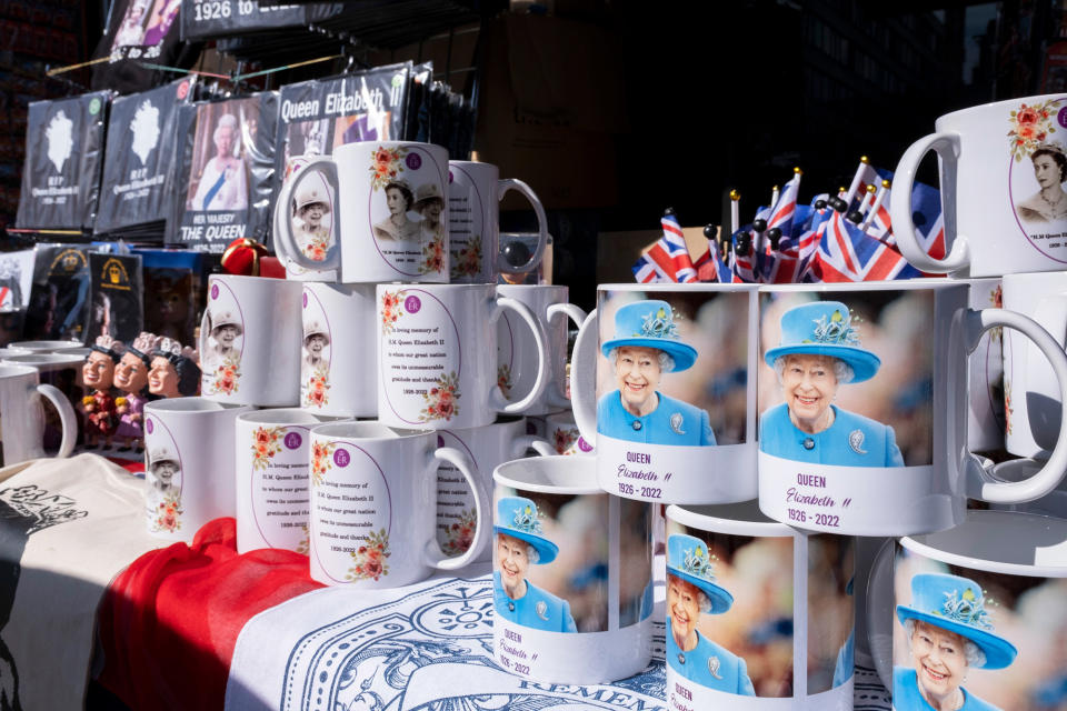 Mugs showing the smiling Queen with "Queen Elizabeth II" on them and the dates 1926–2022