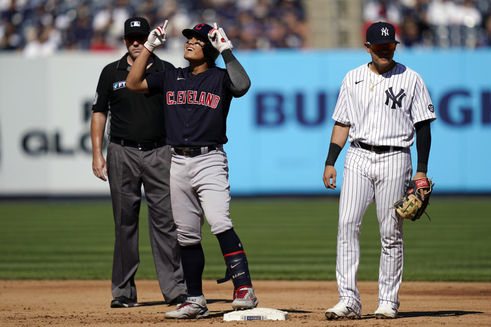 Cleveland Indians' Yu Chang, left, celebrates after hitting a two-run double off New York Yankees relief pitcher Albert Abreu in the fifth inning of a baseball game, Saturday, Sept. 18, 2021, in New York. (AP Photo/John Minchillo)