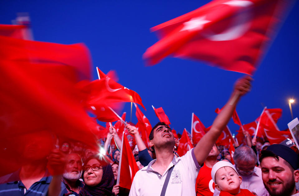 <p>People wave Turkey’s national flags as they attend a ceremony marking the first anniversary of the attempted coup at the Bosphorus Bridge in Istanbul, Turkey, July 15, 2017. (Photo: Osman Orsal/Reuters) </p>