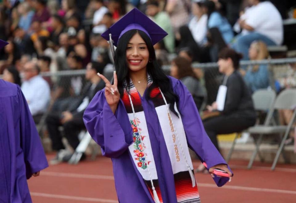 A Madera South High graduate walks to her seat during the graduation ceremony at Madera Memorial Stadium on June 7, 2023.