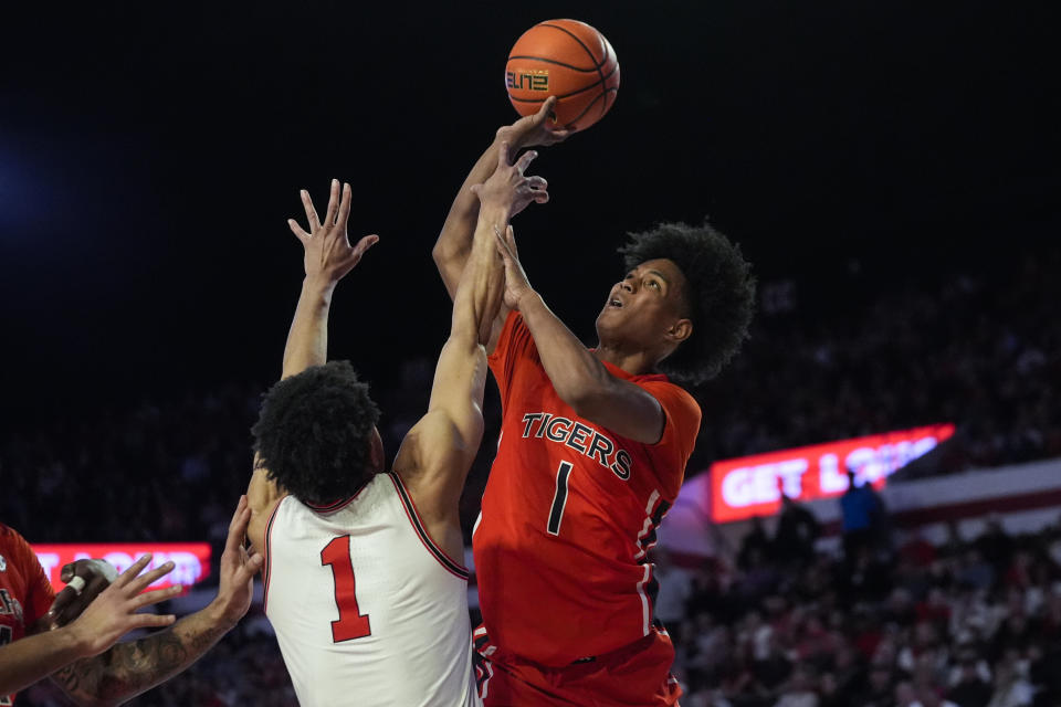 Auburn guard Aden Holloway (1) shoots as Georgia guard Jabri Abdur-Rahim (1) defends during the first half of an NCAA college basketball game Saturday, Feb. 24, 2024, in Athens, Ga. (AP Photo/John Bazemore)