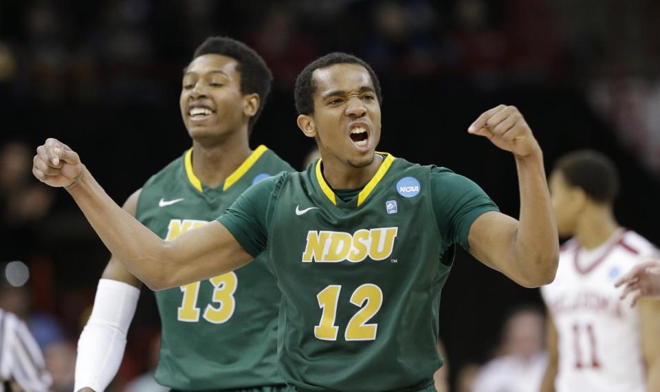 North Dakota State's Lawrence Alexander (12) celebrates in overtime during a second-round game against Oklahoma in the NCAA men's college basketball tournament in Spokane, Wash., Thursday, March 20, 2014. North Dakota State won 80-75. (AP Photo/Elaine Thompson)