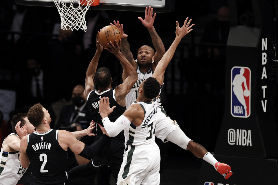 Milwaukee Bucks forward P.J. Tucker defends against a shot by Brooklyn Nets forward Kevin Durant during the first half of Game 1 of an NBA basketball second-round playoff series Saturday, June 5, 2021, in New York. (AP Photo/Adam Hunger)