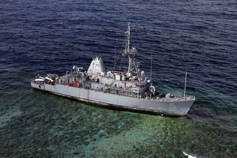 This file photo shows USS Guardian warship, on January 22, 2013, sitting aground on the Tubbataha Reef in the Sulu Sea, Philippines, where it ran aground five days earlier. The Philippines will ask the US to pay $1.4 mln in compensation for damage caused by the ship to a protected coral reef, according to the manager of the reef