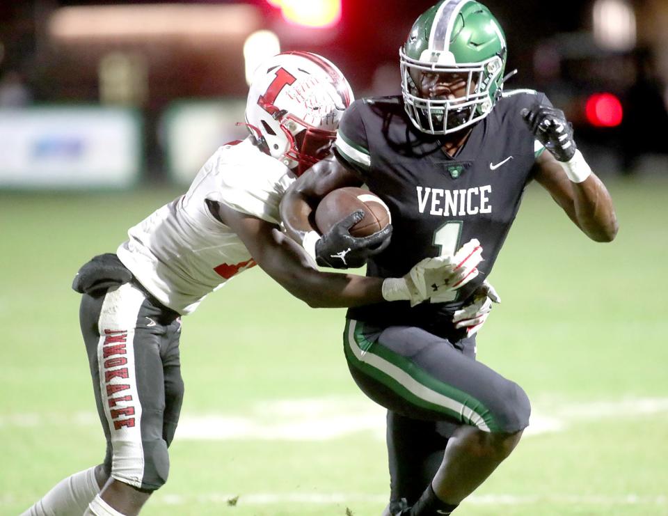 Venice corner back Charles Lester (1) heads upfield with ImmokaleeÕs Marshon Jackson (14) in tow during 2023 FHSAA Friday night playoff action in Venice. Venice handily defeated Immokalee 56-14 to advance. MATT HOUSTON/HERALD-TRIBUNE