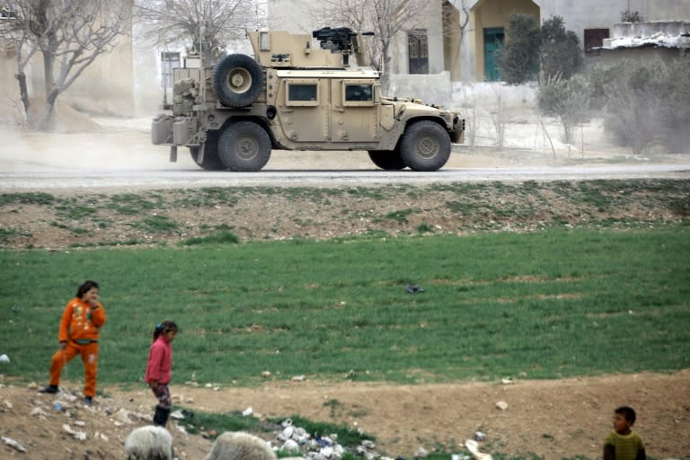 US forces drive a humvee as they patrol the roads surrounding the northern Syrian city of Manbij on March 3, 2017