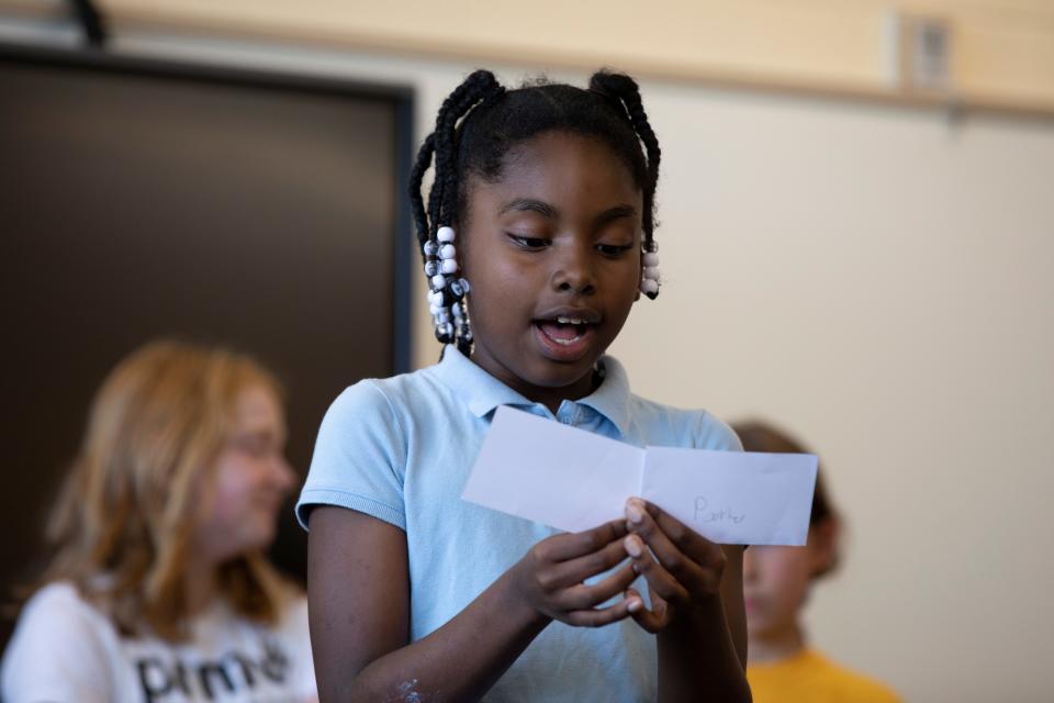 Parker Williams, a third grader at Pleasant Ridge Montessori School, reads from a notecard while presenting a group science project in teacher Sarah Lofquist’s class May 24.