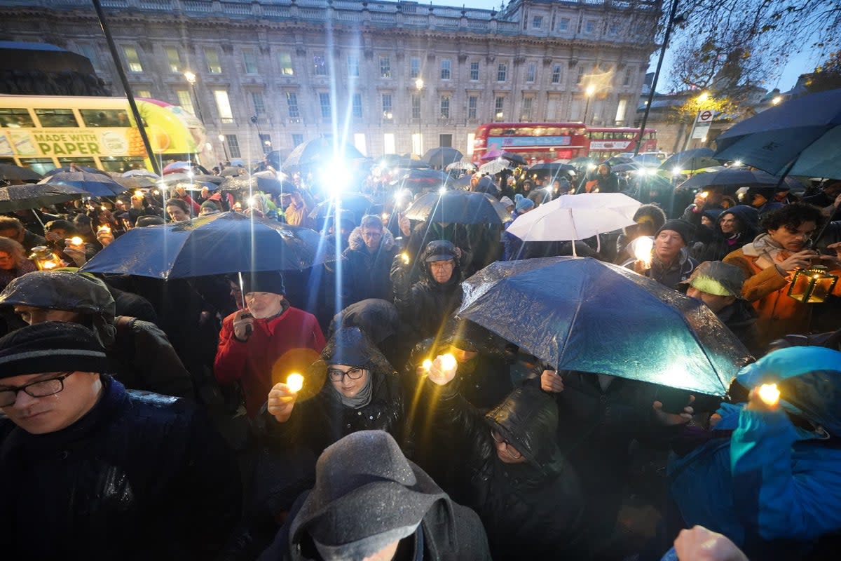 People hold candles during an anti-hate vigil on Whitehall in central London (PA Wire)