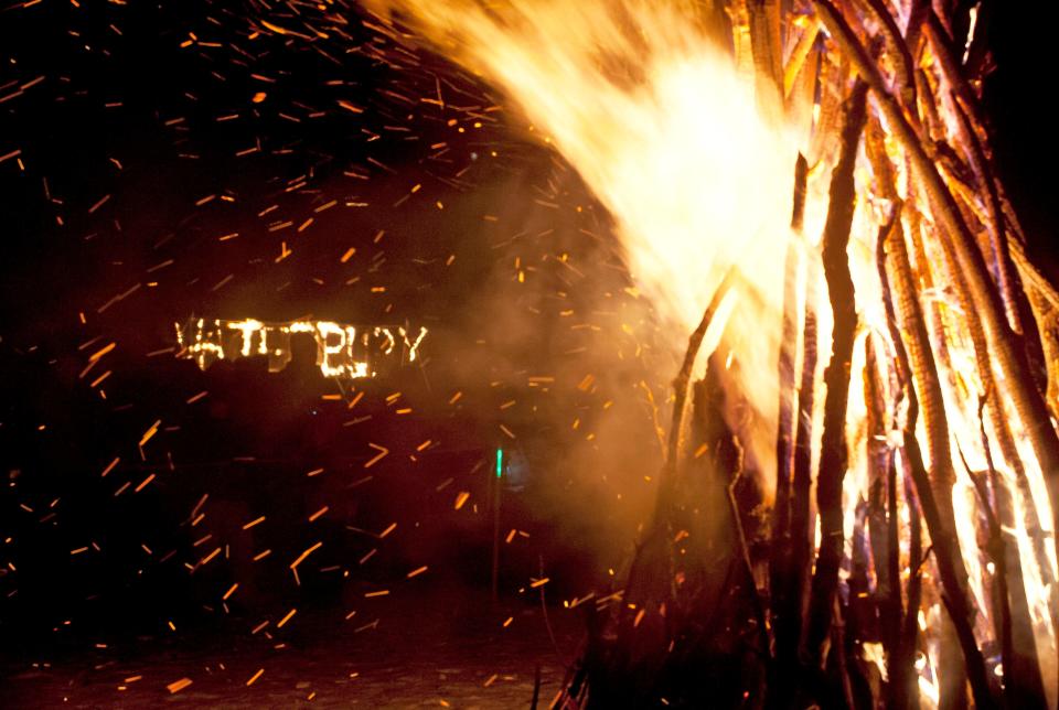 A bonfire and a burning Waterbury sign punctuate the end of the fifth annual River of Light lantern parade in Waterbury on Saturday, December 6, 2014.