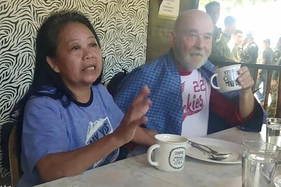 In this image provided by Armed Forces of the Philippines, Task Force Sulu, British national Allan Hyrons and his Filipino wife Wilma gesture inside a military camp at Jolo, Sulu province, southern Philippines on Monday Nov. 25, 2019. A Philippine general says troops have rescued the British man and his Filipino wife who were abducted by gunmen in their beach resort in the south last month and taken to the jungle hideouts of local militants allied with the Islamic State group. (Armed Forces of the Philippines, Joint Task Force Sulu via AP)