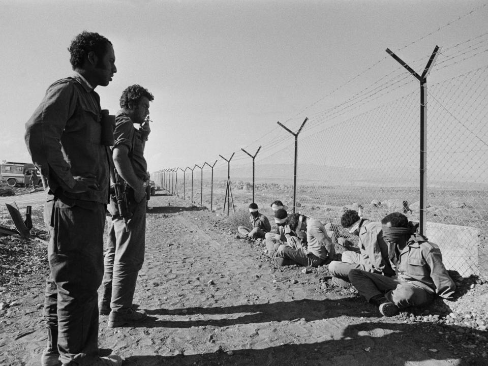 A black and white photo of Syrian prisoners at the Israeli/Syrian border in the Golan Heights.