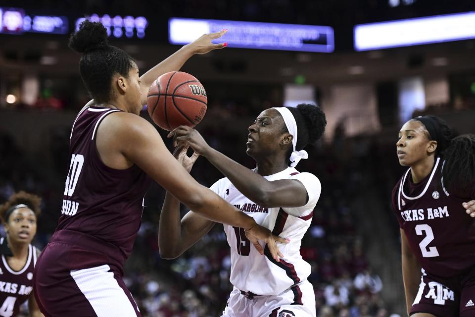 South Carolina forward Laeticia Amihere (15) battles for a loose ball against Texas A&M center Ciera Johnson (40) during the first half of an NCAA college basketball game Sunday, March 1, 2020, in Columbia, S.C. (AP Photo/Sean Rayford)