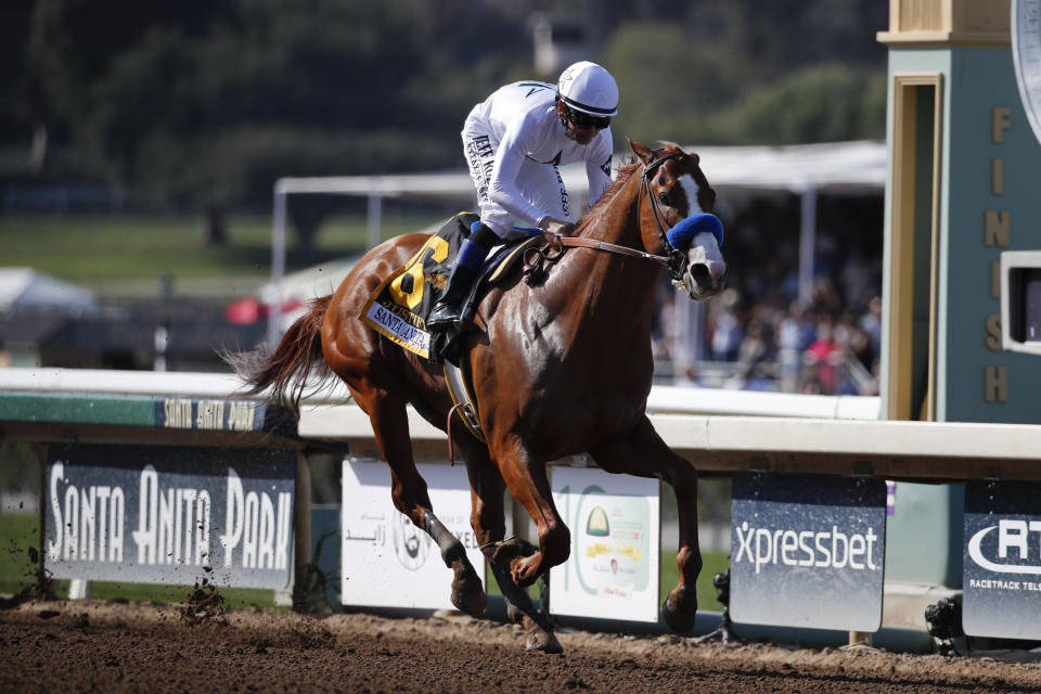 Justify, ridden by Mike Smith, crosses the finish line to win the Santa Anita Derby horse race at Santa Anita Park, Saturday, April 7, 2018, in Arcadia, Calif. (AP)