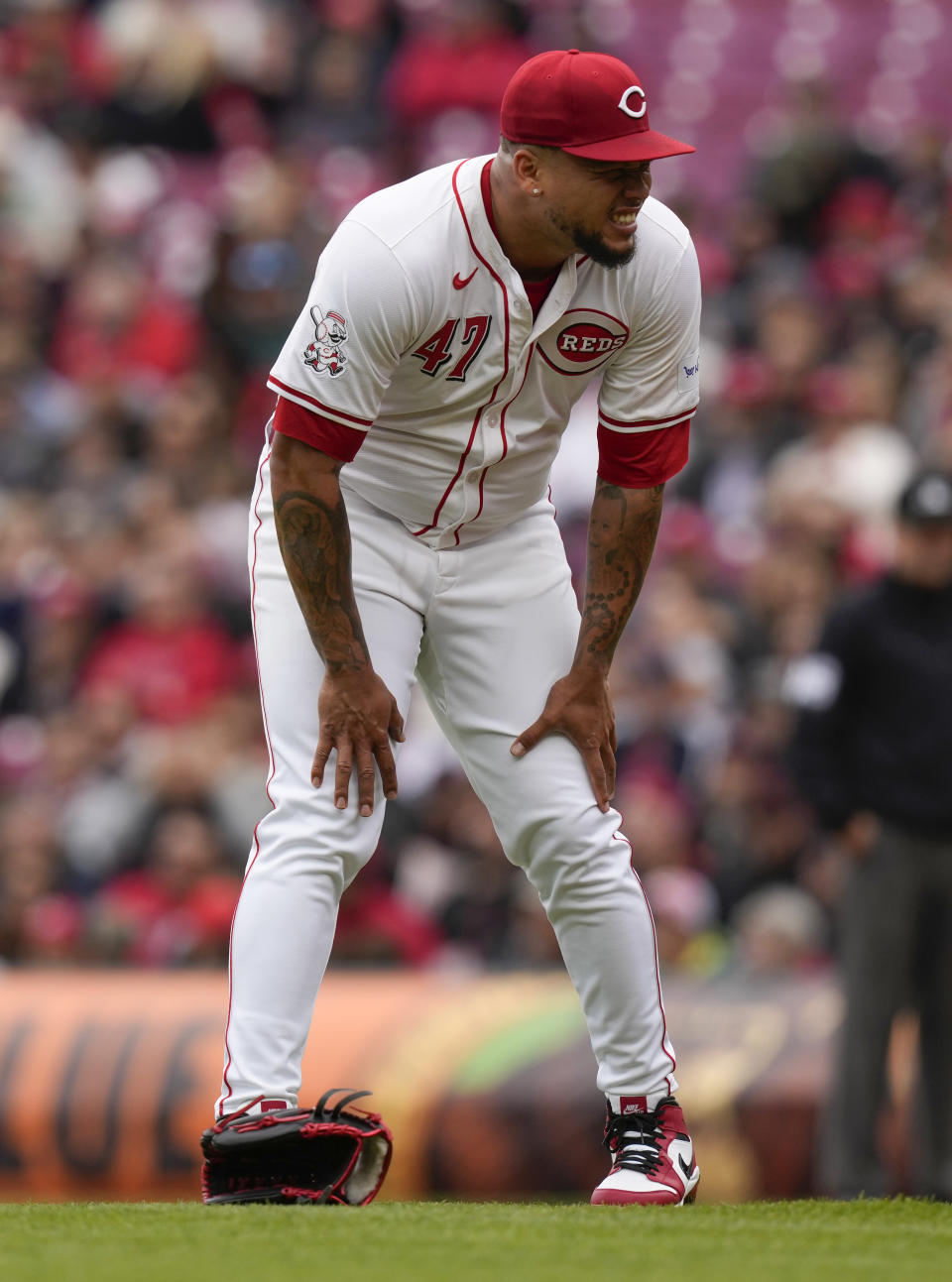 Cincinnati Reds starting pitcher Frankie Montas reacts after being hit by a line drive by Los Angeles Angels' Taylor Ward in the first inning of a baseball game Sunday, April 21, 2024, in Cincinnati. Montas left the game after the injury. (AP Photo/Carolyn Kaster)