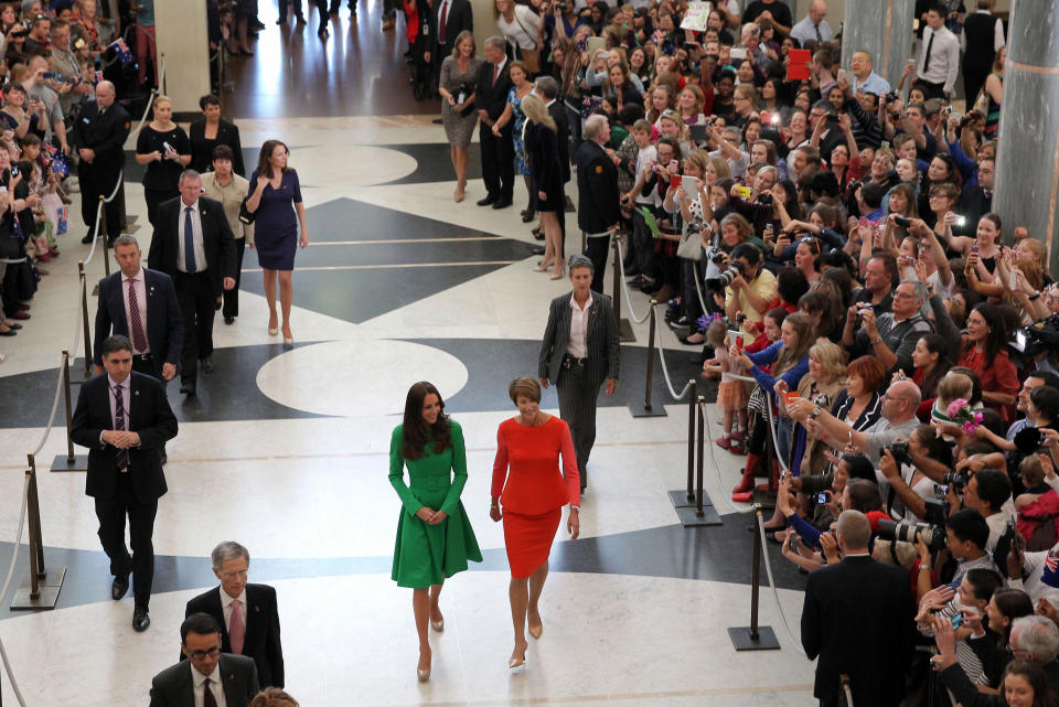 Britain's Kate, Duchess of Cambridge, center left is accompanied by Margie Abbott, center right, wife of Prime Minister Tony Abbott, as they arrive for a reception Thursday, April 24, 2014, at Parliament House in Canberra, Australia. . (AP Photo/Alex Ellinghausen, Pool)