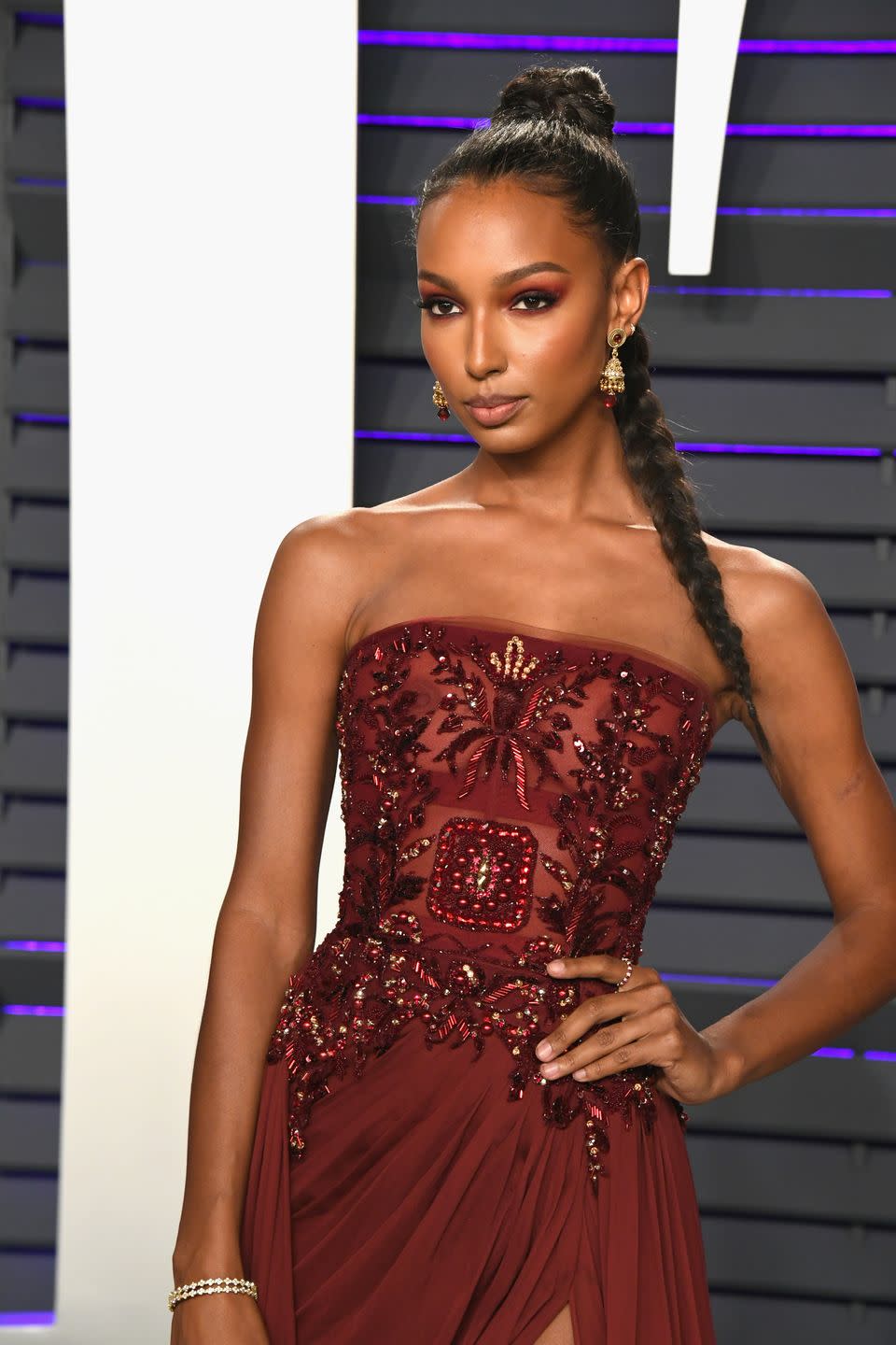 <p>Victoria's Secret Angel Jasmine Tookes wore a killer braided ponytail and maroon eyeshadow to match her gown.</p>