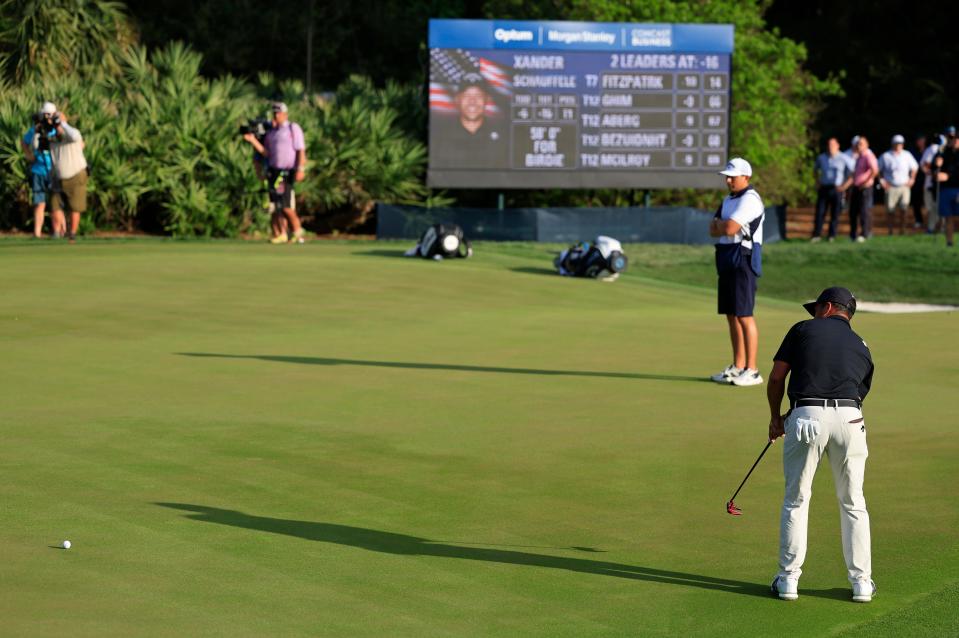 Xander Schauffele sinks a 58-foot putt for birdie on the Players Stadium Course's 14th hole on Saturday during the third round of The Players Championship.