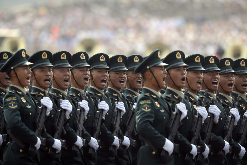 Members of China's People's Liberation Army (PLA) Rocket Force let out a yell as they march in formation during a parade to commemorate the 70th anniversary of the founding of Communist China in Beijing, Tuesday, Oct. 1, 2019. Trucks carrying weapons including a nuclear-armed missile designed to evade U.S. defenses rumbled through Beijing as the Communist Party celebrated its 70th anniversary in power with a parade Tuesday that showcased China's ambition as a rising global force. (AP Photo/Mark Schiefelbein)