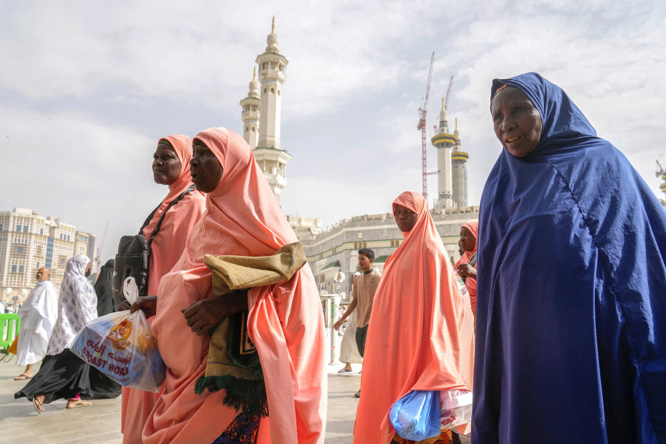 Chadian pilgrims walk outside the Grand Mosque, during the annual hajj pilgrimage, in Mecca, Saudi Arabia, Saturday, June 24, 2023. Muslim pilgrims are converging on Saudi Arabia's holy city of Mecca for the largest hajj since the coronavirus pandemic severely curtailed access to one of Islam's five pillars. (AP Photo/Amr Nabil)