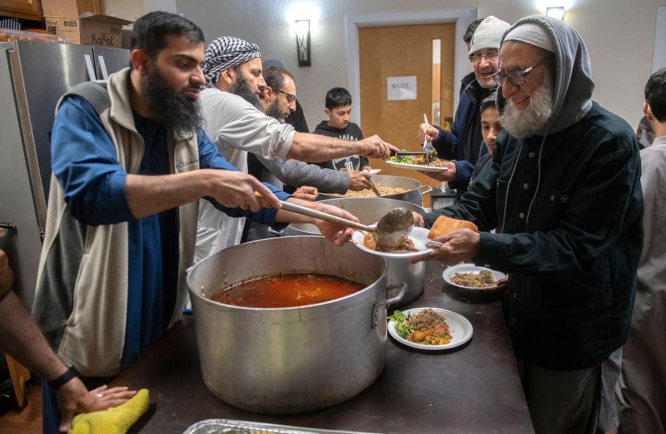 Congregation members line up for the evening meal during Ramadan at the  Masjid Al-Emaan mosque in Stockton on Tuesday, Apr. 18, 2023. CLIFFORD OTO/THE STOCKTON RECORD