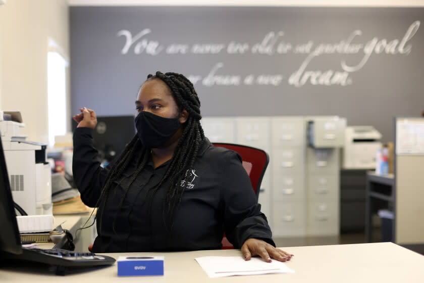 SAN BERNARDINO , CA - SEPTEMBER 23: Tawna Whitfield gets some last minute things in order before teaching an Employment Development class to formally incarcerated clients at The Time for Change Foundation where she works on Wednesday, Sept. 23, 2020 in San Bernardino , CA. She lost her nursing license and her section 8 housing after pleading to a felony gun charge in 2013 after prosecutors told her it was option that would allow her to go home that day instead of going to prison.(Dania Maxwell / Los Angeles Times)