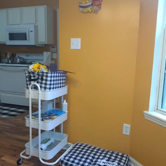 Reviewer's photo of the utility cart in the color white, used to organize items in a kitchen