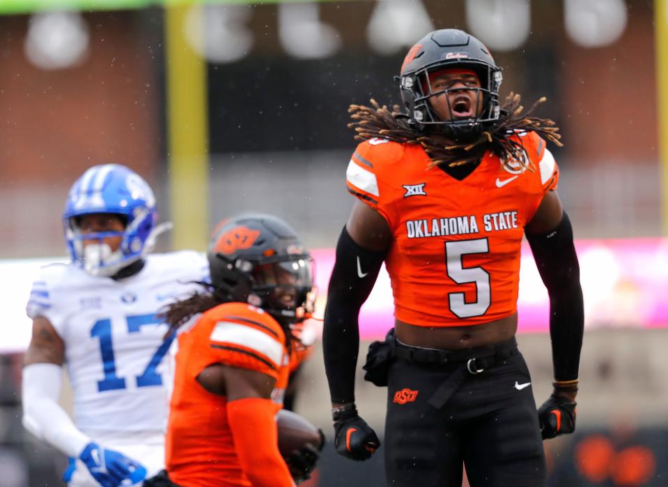 Nov 25, 2023; Stillwater, Oklahoma, USA; Oklahoma State's Kendal Daniels (5) celebrates an Oklahoma State fumble recovery during the first half of the college football game between the Oklahoma State University Cowboys and the Brigham Young Cougars at Boone Pickens Stadium. Mandatory Credit: Sarah Phipps-USA TODAY Sports