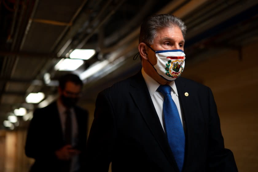 WASHINGTON, DC - MARCH 05: Sen. Joe Manchin (D-WV) walks on the senate side of the Capitol Building on Friday, March 5, 2021 in Washington, DC. The Senate finally took up the $1.9 trillion Covid relief package and continues to debate it, with infighting within the Senate Democrat ranks over unemployment benefits threatens to hinder progress. (Kent Nishimura / Los Angeles Times)