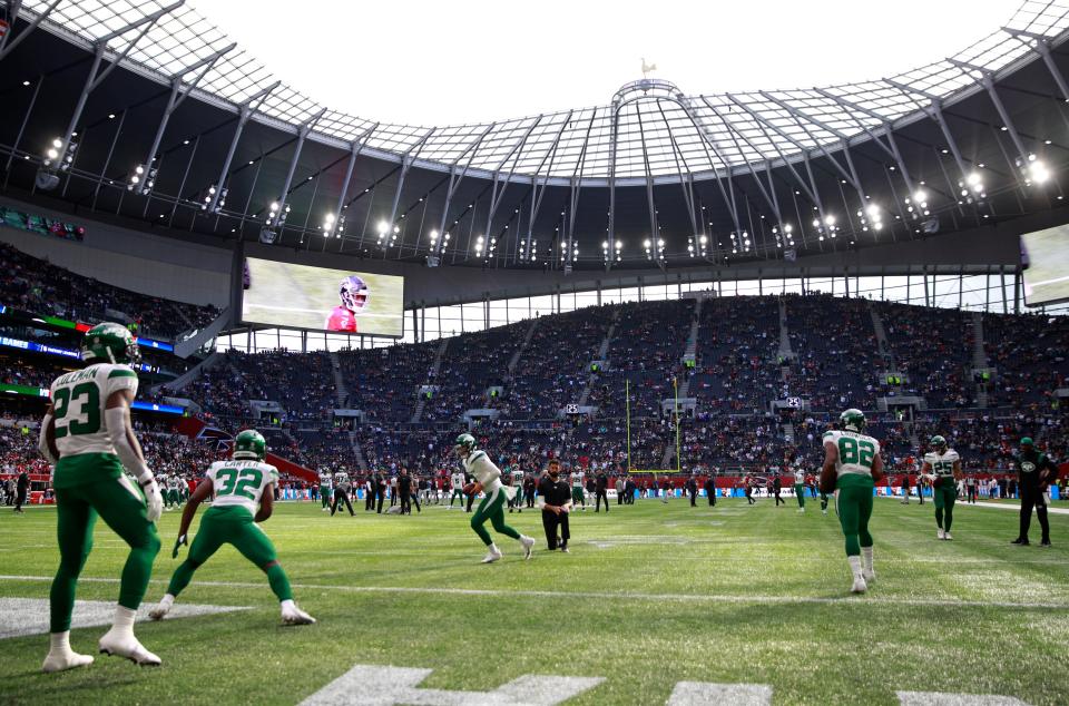 New York Jets players warm-up before an NFL football game between the New York Jets and the Atlanta Falcons at the Tottenham Hotspur stadium in London, England, Sunday, Oct. 10, 2021. (AP Photo/Ian Walton)