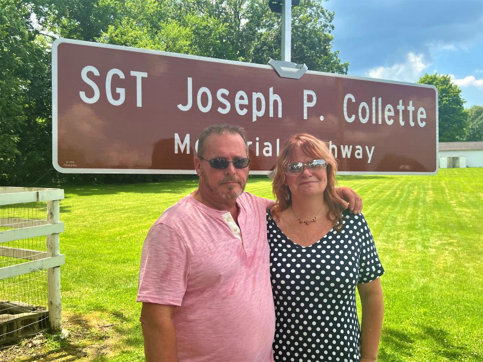 Joseph Collette and Teri Mecionis, parents of the late Army Sgt. Joseph Collette, stand in front of a sign that the Ohio Department of Transpiration placed at Ginder Road and Ohio 158 honoring part of the highway in their son's honor.