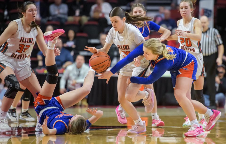 Illini Bluffs' Brenna Davis, middle, and Okawville's Madisyn Wienstroer, right, chase a loose ball in the second half of their Class 1A girls basketball state title game Saturday, March 2, 2024 at CEFCU Arena in Normal. The Tigers fell 48-36 to the Lady Rockets.