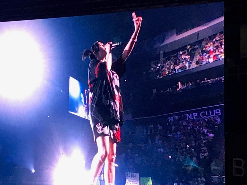 Billie Eilish looks toward the upper level at PPG Paints Arena on Tuesday.