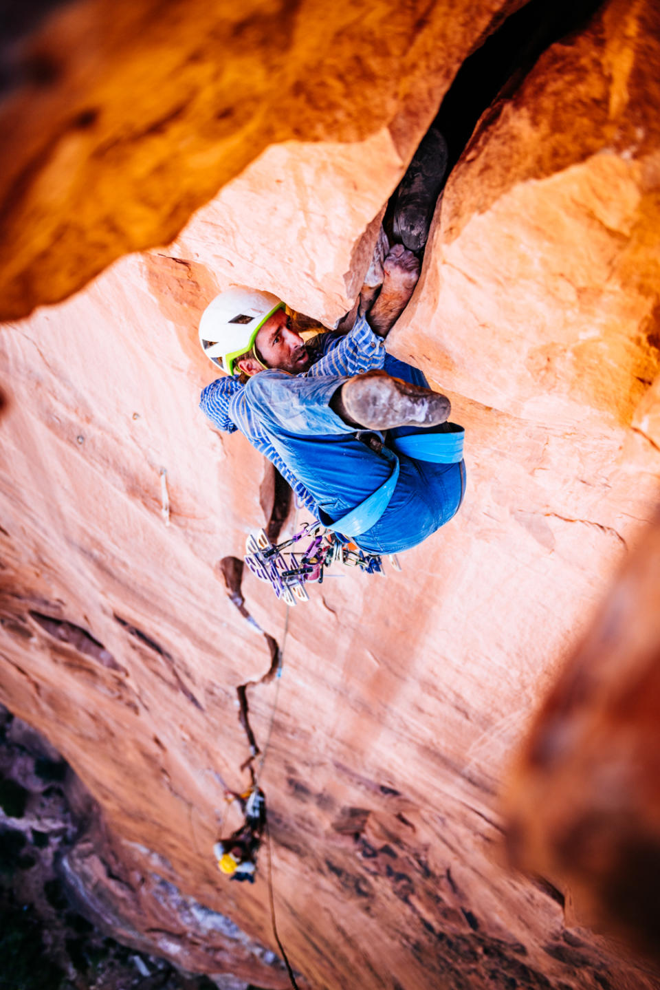 Climbing a sandstone offwidth crack.