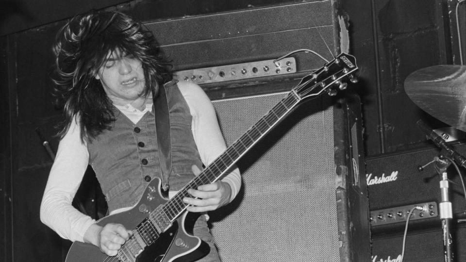 Man playing guitar: AC/DC band members