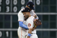 Houston Astros' Jose Altuve, bottom, and Carlos Correa, top, celebrate their win over the Chicago White Sox in a baseball game, Sunday, June 20, 2021, in Houston. (AP Photo/Eric Christian Smith)